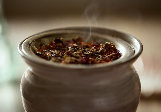 Ayurveda 4 A herbal mixture smokes in a wax melt burner